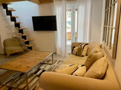 a living room with a couch and a table at La Milange de Porto vecchio in Porto-Vecchio