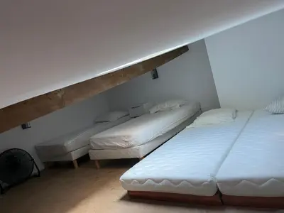 two twin beds in a room with a loft at La Milange de Porto vecchio in Porto-Vecchio
