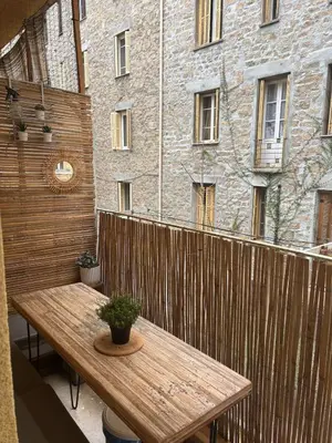 a wooden table with a potted plant on a wooden fence at Eden Studio in Ajaccio