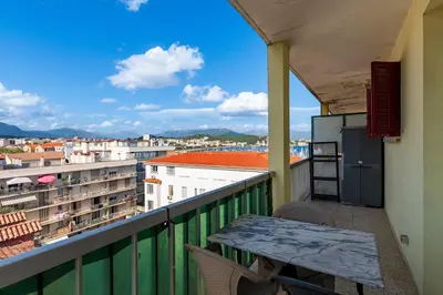 a balcony with a table and a view of a city at Azur Ajaccien - Proche du port avec parking in Ajaccio