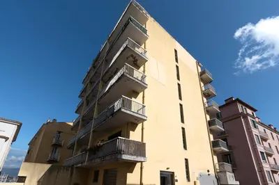 a tall building with balconies on the side of it at Azur Ajaccien - Proche du port avec parking in Ajaccio