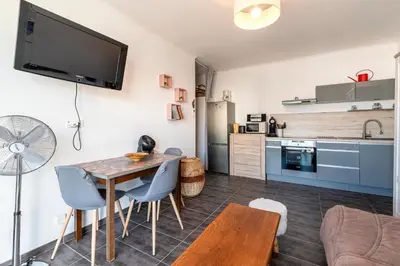 a kitchen and living room with a table and chairs at Azur Ajaccien - Proche du port avec parking in Ajaccio