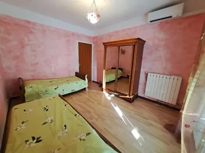 a room with two beds and a mirror at Appartement Ajaccio centre, climatisé, parking in Ajaccio