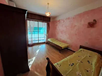 a small room with two beds and a window at Appartement Ajaccio centre, climatisé, parking in Ajaccio