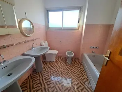 a bathroom with two sinks and a toilet and a mirror at Appartement Ajaccio centre, climatisé, parking in Ajaccio