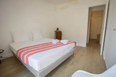 a bedroom with a bed with two towels on it at Helena - Bright 2Br Trottel Beach by foot - by TGB in Ajaccio