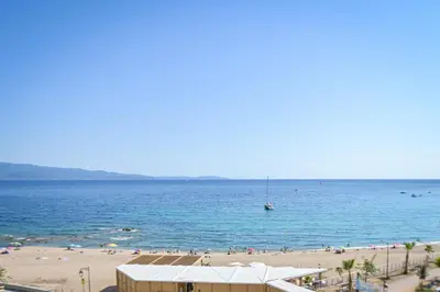 a beach with a lot of people in the water at Helena - Bright 2Br Trottel Beach by foot - by TGB in Ajaccio
