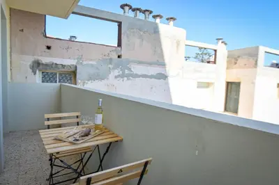 a table and a bottle of wine on a balcony at Helena - Bright 2Br Trottel Beach by foot - by TGB in Ajaccio