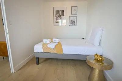 a bedroom with a bed with two towels on it at Helena - Bright 2Br Trottel Beach by foot - by TGB in Ajaccio