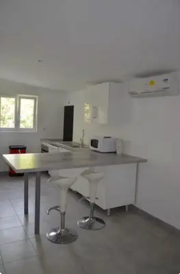 a kitchen with a large counter top in a room at Appartement Porto-Vecchio in Porto-Vecchio