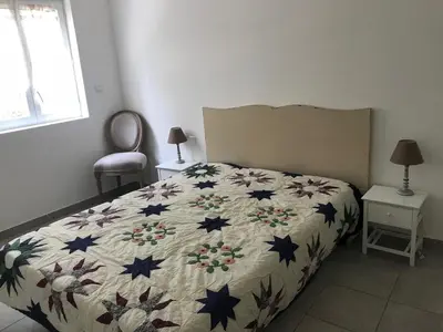 a bedroom with a bed with a comforter with stars at Appartement Porto-Vecchio in Porto-Vecchio