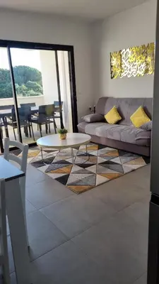 a living room with a couch and a table at BELLE Demeure in Pietrosella