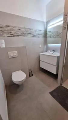 a white bathroom with a toilet and a sink at BELLE Demeure in Pietrosella