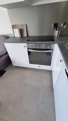 a kitchen with a white counter with a stove at BELLE Demeure in Pietrosella