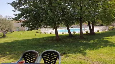 a pair of shoes sitting on a chair in a park at Casa di u sole in Santa-Maria-Poggio