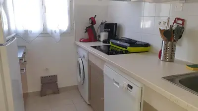 a kitchen with a stove top oven next to a sink at Casa di u sole in Santa-Maria-Poggio