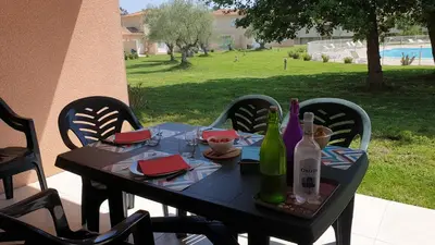 a black table with wine bottles on a patio at Casa di u sole in Santa-Maria-Poggio