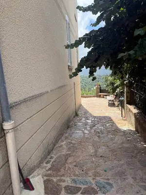 a side walk next to a building with a pipe at Villa Marcelle in Evisa