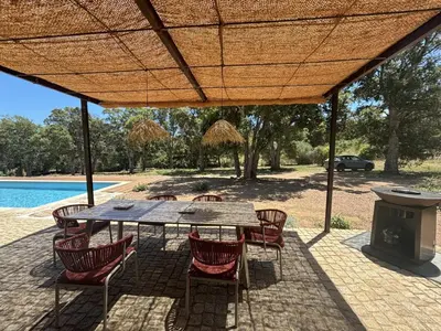 a patio with a table and chairs and a grill at Villa neuve pinarello avec piscine privée, plage à 450m in Zonza