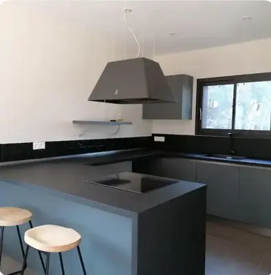 a kitchen with a sink and two stools at Villa neuve pinarello avec piscine privée, plage à 450m in Zonza