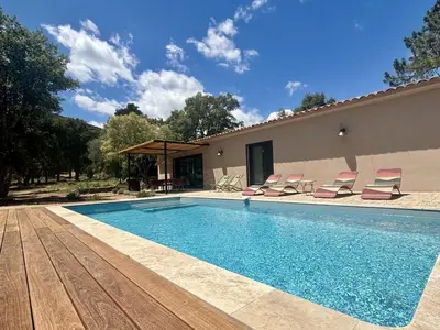 a swimming pool with chairs and a house at Villa neuve pinarello avec piscine privée, plage à 450m in Zonza