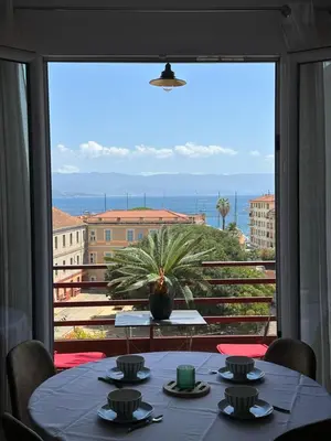 a table in a room with a large window at Appartement F3 vue mer in Ajaccio