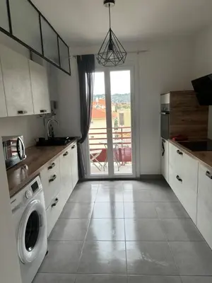 a kitchen with a washer and dryer in it at Appartement F3 vue mer in Ajaccio