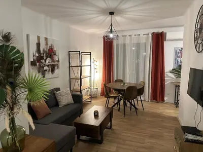 a living room with a couch and a table at Appartement F3 vue mer in Ajaccio