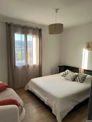 a bedroom with a large bed and a window at Appartement F3 vue mer in Ajaccio