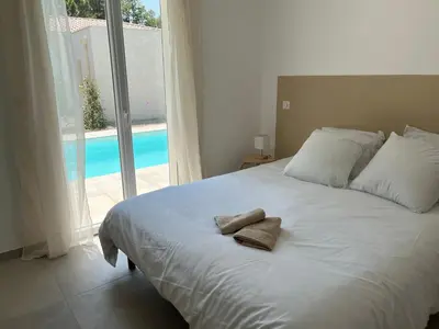 a bedroom with a bed with two towels on it at Villa L et Villa J in Prunelli-di-Fiumorbo