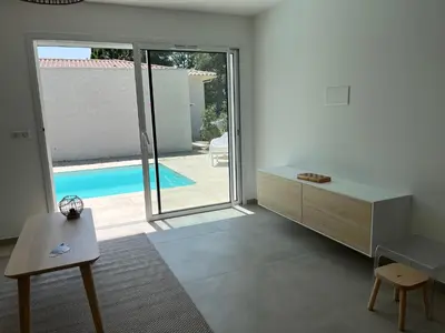 a living room with a view of a swimming pool at Villa L et Villa J in Prunelli-di-Fiumorbo