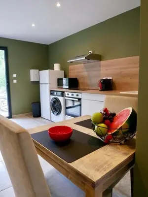 a kitchen with a table with a bowl of fruit on it at Casa Alta in Zonza