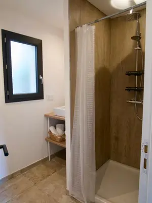 a shower with a shower curtain in a bathroom at Casa Alta in Zonza