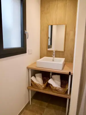 a bathroom with a sink and baskets at Casa Alta in Zonza