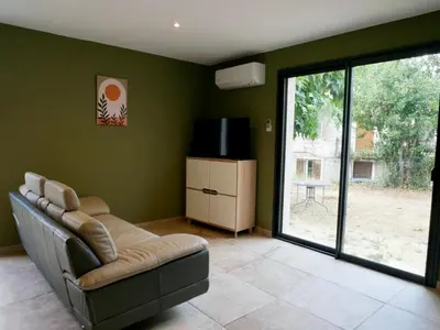 a living room with a couch and a television at Casa Alta in Zonza