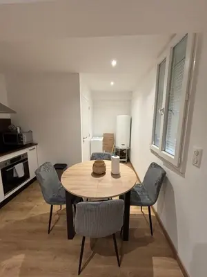 a kitchen with a table and chairs in a room at Appartement Ajaccio studio in Ajaccio