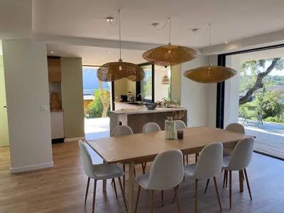 a kitchen and dining room with a wooden table and chairs at Villa & Casa Sadrea in Lecci