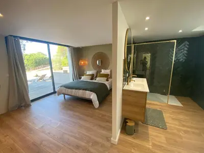 a bedroom with a bed and a sink and a mirror at Villa & Casa Sadrea in Lecci
