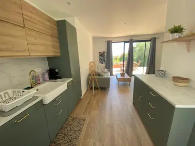 a kitchen with green cabinets and a white sink at Villa & Casa Sadrea in Lecci