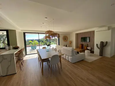 a kitchen and living room with a table and a couch at Villa & Casa Sadrea in Lecci
