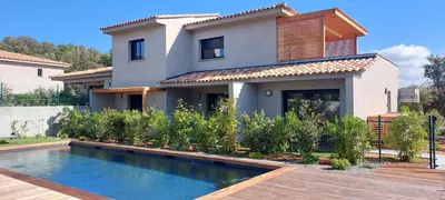 a house with a swimming pool in front of a house at résidence Terra Verde in Porto-Vecchio