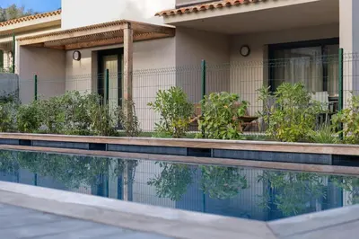 a house with a swimming pool in front of it at résidence Terra Verde in Porto-Vecchio