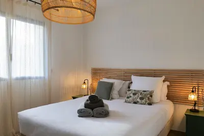 a bedroom with a large white bed with towels on it at résidence Terra Verde in Porto-Vecchio