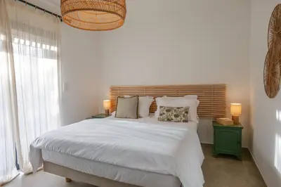 a bedroom with a bed with white sheets and pillows at résidence Terra Verde in Porto-Vecchio