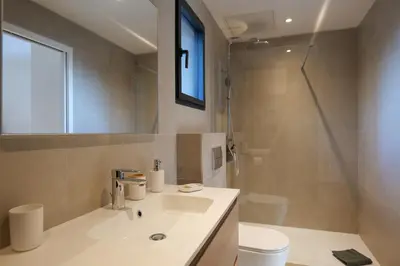 a bathroom with a sink and a toilet and a mirror at résidence Terra Verde in Porto-Vecchio