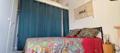 a bedroom with a bed and a blue curtain at Casa Di l'alba in Borgo