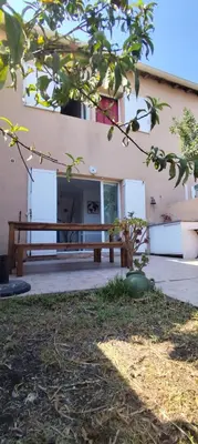 a wooden bench sitting in front of a building at Casa Di l'alba in Borgo