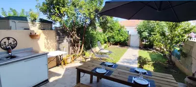 a patio with a table and an umbrella at Casa Di l'alba in Borgo