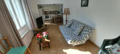 a living room with a couch and a table at Agréable bas de villa in Furiani