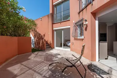 a chair sits outside of a building at Canelli - Magnifique Vue Mer in Pietrosella